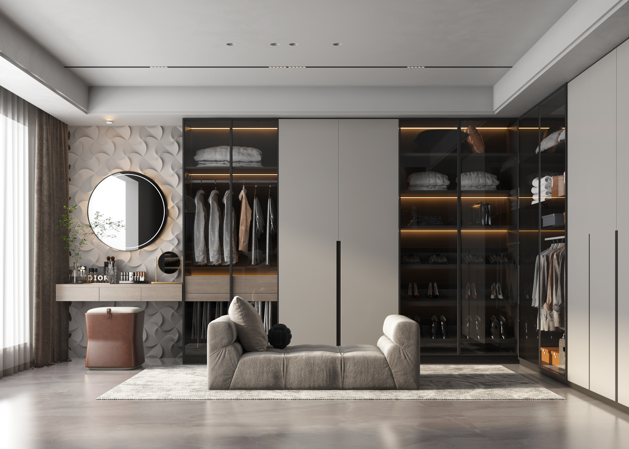Modern walk-in closet with glass-front wardrobes, vanity, and lounge seating.