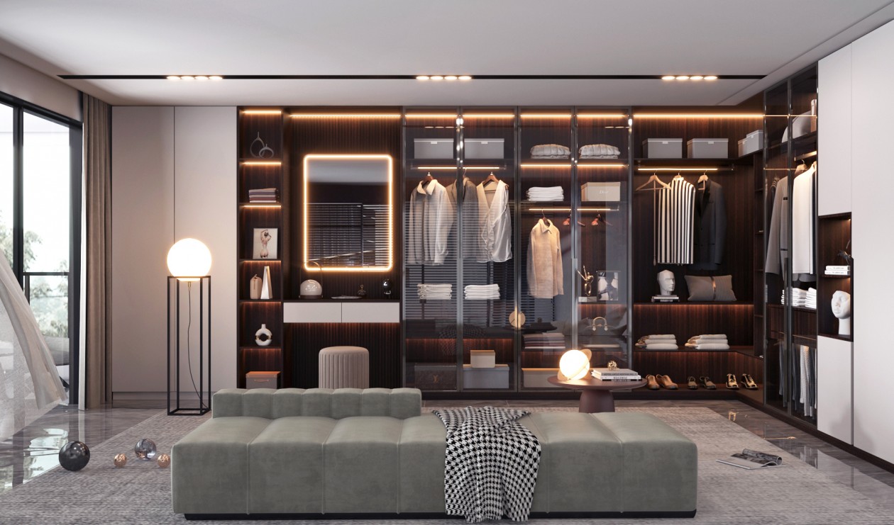 Luxurious walk-in closet with custom shelving, a dressing area, and a gray upholstered bench.